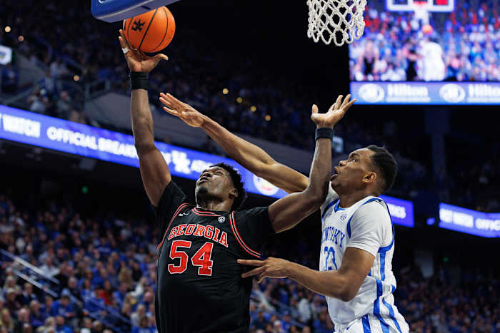Jan 20, 2024; Lexington, Kentucky, USA; Georgia Bulldogs center Russel Tchewa (54) goes to the basket against Kentucky Wildcats forward Ugonna Onyenso (33) during the first half at Rupp Arena at Central Bank Center. Mandatory Credit: Jordan Prather-USA TODAY Sports